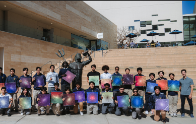 Students standing in front of Triton Statue with Ethan Nadler