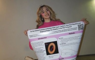 Clarissa Do holding up a research poster
