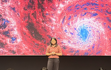 Mansi Padave giving a talk in front of an audience